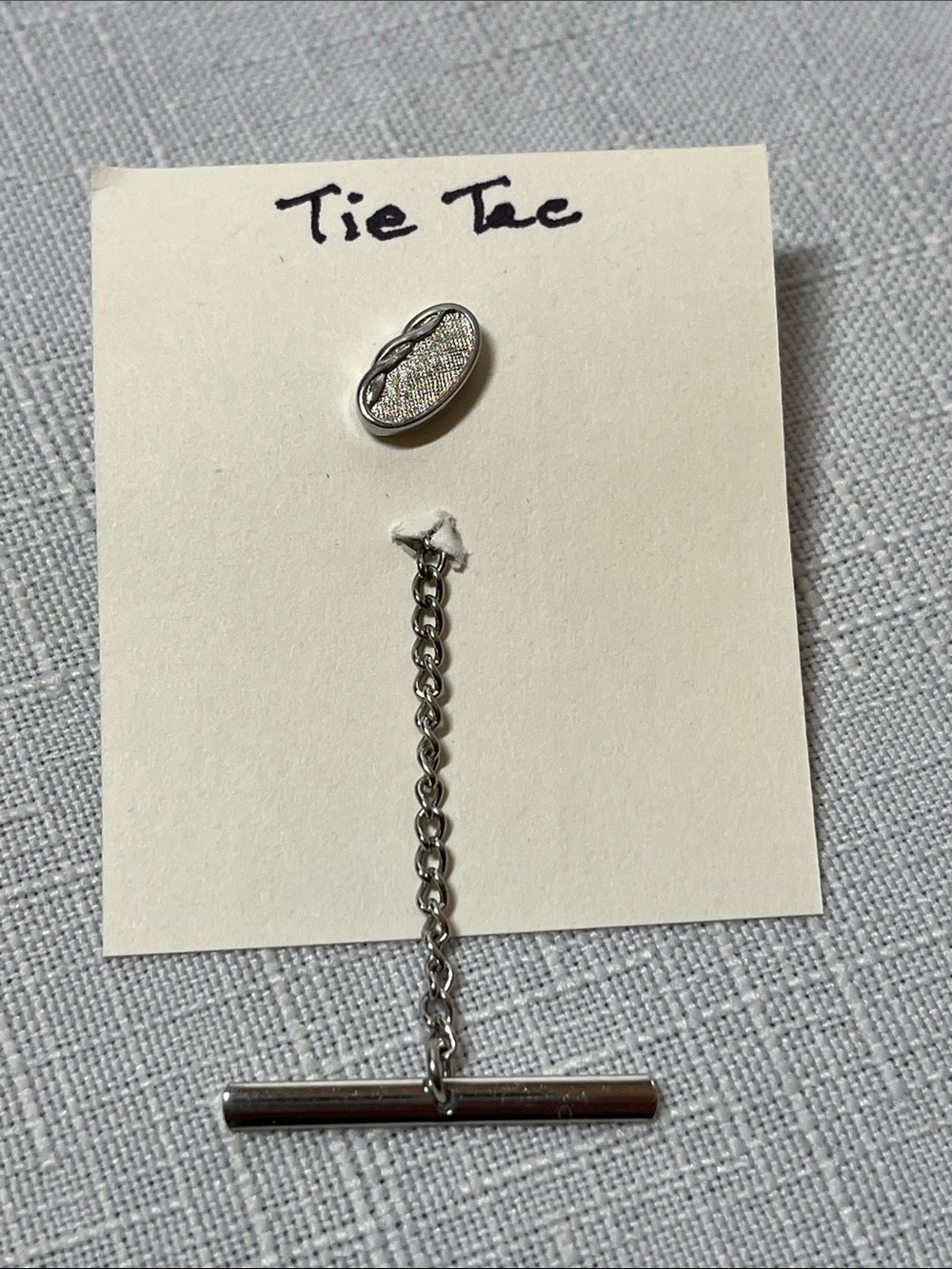 Vintage silvertone Swank tie tack
abstract oval design textured finish